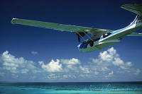 Bahamas, Bimini Island, Catalina PBY-5a hydroplane flying low over sea and reef. Peter Stuyvesant Travel Odyssey 1993/1994.