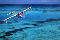 Bahamas, Bimini, Catalina PBY-5A hydroplane flying over reef. Peter Stuyvesant Travel Odyssey 1993/1994.
